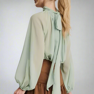 Soft, flowing Georgette fabric and delicate pleating with high neckline adds a touch of classic romance, while the billowy sleeves brings a little drama with subtle volume and texture