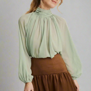 Soft, flowing Georgette fabric and delicate pleating with high neckline adds a touch of classic romance, while the billowy sleeves brings a little drama with subtle volume and texture