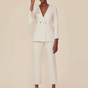 Collarless ecru cream color blazer with gold medallion buttons. Chic and stylish blazer pant suit in classic cut