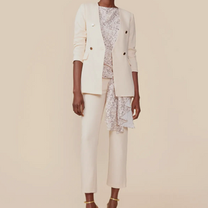 Collarless ecru cream color blazer with gold medallion buttons. Chic and stylish blazer pant suit in classic cut