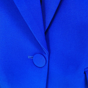 Bright cobalt royal  blue women’s pantsuit with structured blazer and flared trousers, tailored for a bold professional look.