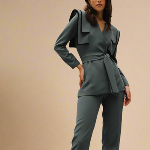 Pewter Blue Grey suit in a unique exaggerated shoulder with belted tie blazer and cropped ankle length trouser. 