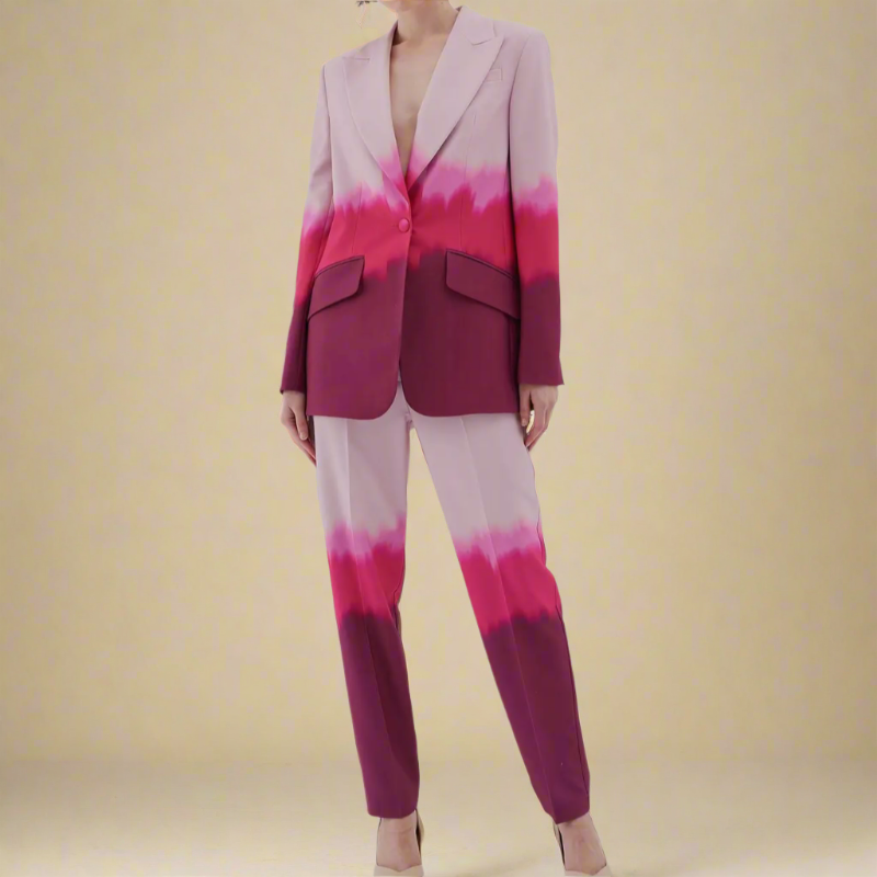 Plus size suit in shades of pink and red ombre print with notched collar, single-breasted blazer and matching trousers.