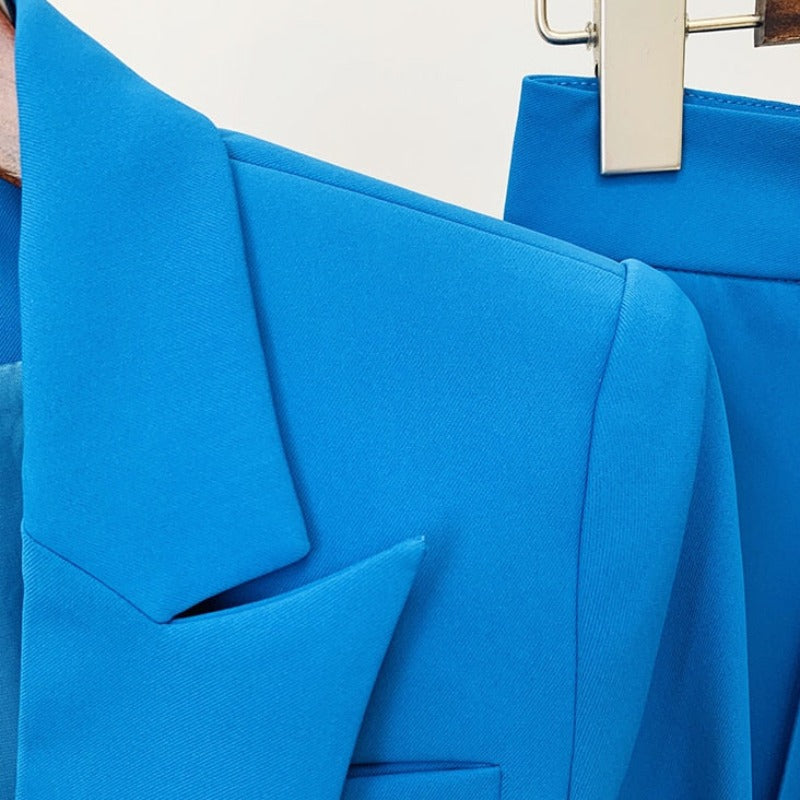 Bold and powerful woman's pant suit in bold bright azure blue, pink and yellow. Tailored cut flattering the curves while still being professional and conservative enough for any business meeting or the office. 