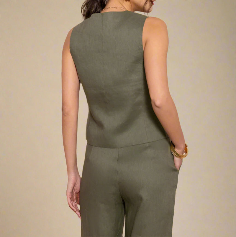 Woman wearing a green linen against a beige background