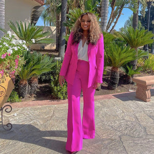 Bold and powerful woman's pant suit in bold fuchsia pink and yellow. Tailored cut flattering the curves while still being professional and conservative enough for any business meeting or the office. 